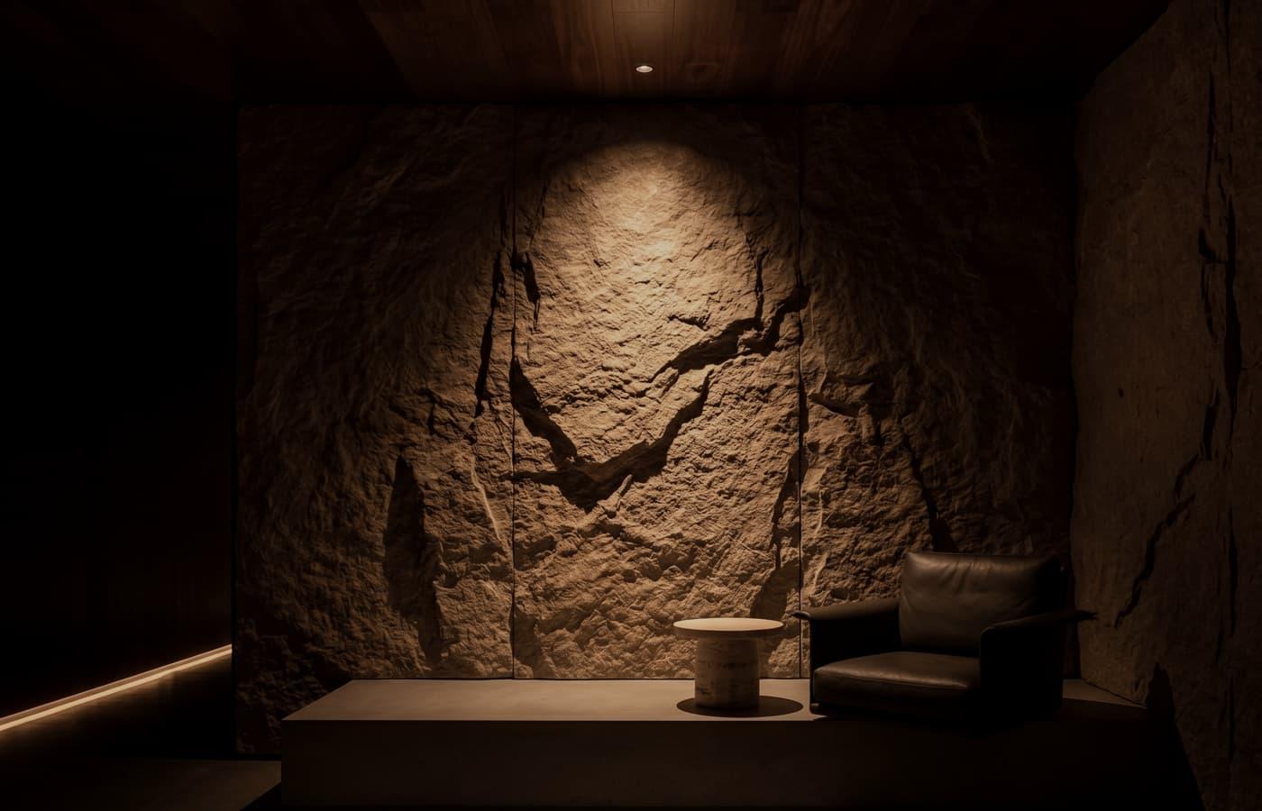 A dark stone interior alcove with a focused architectural light plane